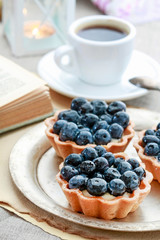 Blueberries cake and cup of coffee.