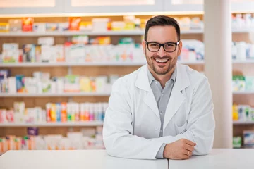 Wall murals Pharmacy Smiling portrait of a handsome pharmacist.