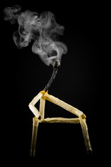 image of a man made of matchstick. Small and depressive in the dark, erased and losing the flame....