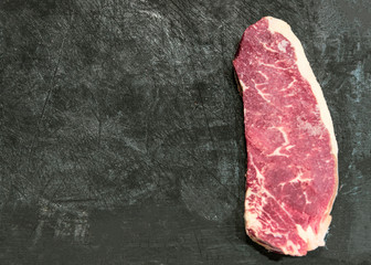 fresh cut  rib eye steak ready for grilling, copy space