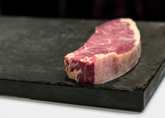 fresh cut  rib eye steak ready for grilling, copy space