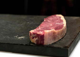 fresh cut  rib eye steak ready for grilling, copy space