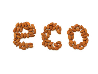 Text Eco made by Almonds nuts on a white background. Pile of selected almonds close up. Organic food