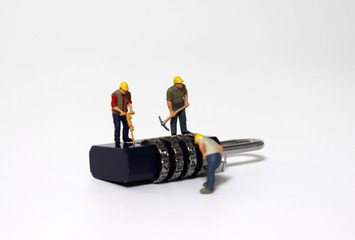 Combination lock and Miniature people. The concept of password theft.