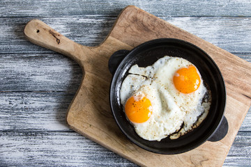 Fried egg. Close up view of the fried egg on a frying pan