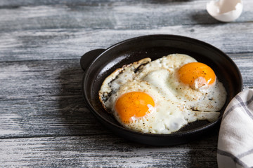 Fried egg. Close up view of the fried egg on a frying pan