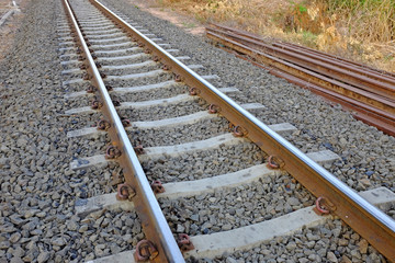 Steel support rails with concrete sleepers strewn with gravel 