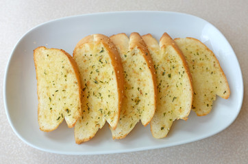 Home-made Garlic and herb bread slices on plate