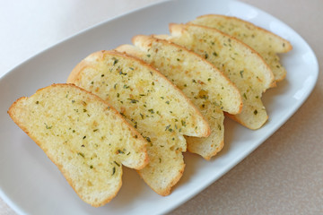 Home-made Garlic and herb bread slices on plate