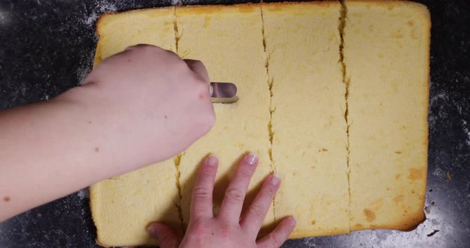 Lady Using Pizza Cutter To Cut Across Plain Cake In Order To Shape It Into Squares To Fill With Egg Cream 4K 30FPS - Flour, Sugar, Sweet, Shaped