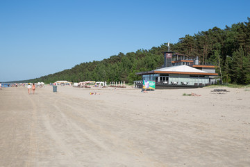 Fototapeta premium City Jurmala, Latvian Republic. Peoples walking on sand beach and sunbathing. Travel photo. 2019. 4. Jun.