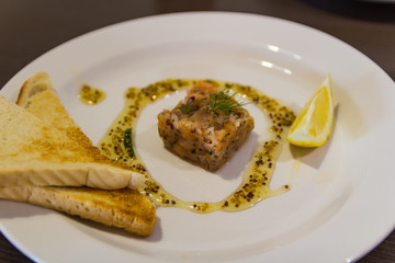 Raw smoked salmon with lemon and fried toast, healthy food on plate
