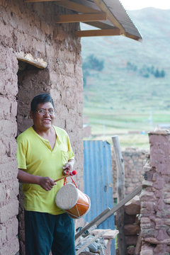 Native american man playing typical sikuri drums.
