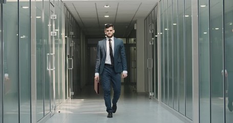 Caucsaian businessman doing victory dance in office hall. Young manager celebrating his successful achievement by dance break - way to success concept 4k