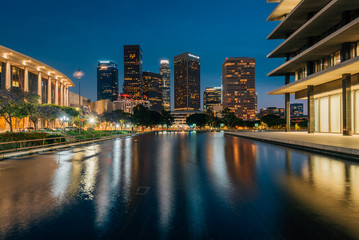 The downtown Los Angeles skyline at night, with the reflecting pool at the Department of Water and Power, in Los Angeles, California