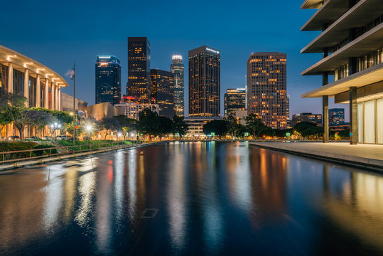 The downtown Los Angeles skyline at night, with the reflecting pool at the Department of Water and Power, in Los Angeles, California
