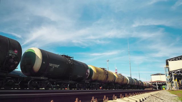 large cisterns stand on railway at refinery complex timlapse