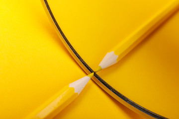 Yellow pencil on color background with mirror.