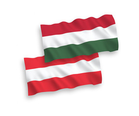 National vector fabric wave flags of Austria and Hungary isolated on white background. 1 to 2 proportion.