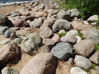 Many large stones by the sea