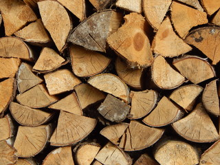 Fresh firewood stacked in piles, close-up view