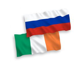 National vector fabric wave flags of Ireland and Russia isolated on white background. 1 to 2 proportion.