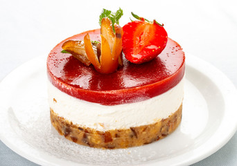 Creamy dessert with strawberry jelly and biscuit. On white background.