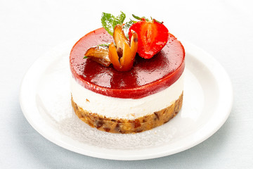 Creamy dessert with strawberry jelly and biscuit. On white background.