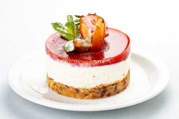 Creamy dessert with strawberry jelly and biscuit. On white background.