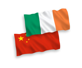 National vector fabric wave flags of Ireland and China isolated on white background 1 to 2 proportion.