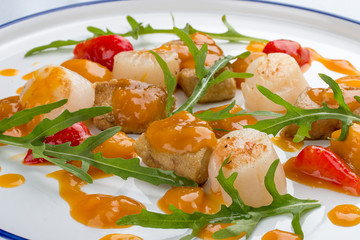 Scallop with strawberries and arugula. On white background