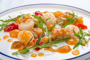 Scallop with strawberries and arugula. On white background