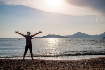 Man meets sunset on the sea shore 