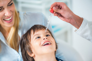 Homeopathy. Mother and little boy visiting a homeopath