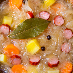 rustic sauerkraut soup with bacon and sausage