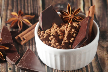 Obraz na płótnie Canvas Cocoa powder and a bar of dark chocolate
