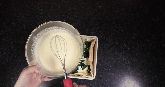 Time Lapse Of Lady About To Add Cream For A Delicious Quiche To Prepare It For Baking 4K 30FPS - Mixture, Cheese, Ricotta, Spinach, Cheddar, Puff Pastry, White Tray, Bowl, Whisk