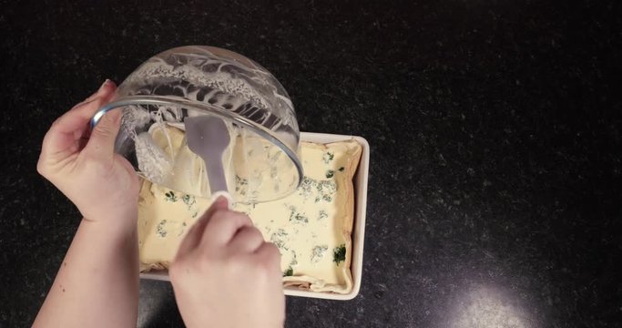 Reverse Shot Of Woman Using Spreader To Scrape Off The Rest Of The Delicious Mixture To Make Scrumtious Spinach And Cheese Quiche 4K 30FPS - Puff Pastry, Cheddar, Ricotta