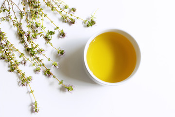 Thyme tea and thyme leaves. Infusion made from thyme leaves. Medicinal herb Thymus vulgaris. The concept of healthy nutrition.