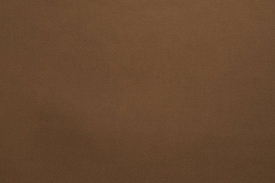Brown felt texture abstract art background. Solid color construction paper surface. Empty space.