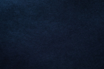 Dark blue felt texture abstract art background. Solid color wool textile. Copy space.