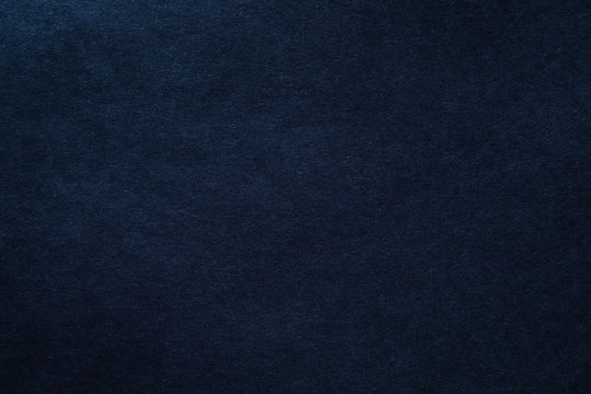Dark blue felt texture abstract art background. Solid color wool textile. Copy space.