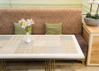 modern restaurant interior with sofa and flowers