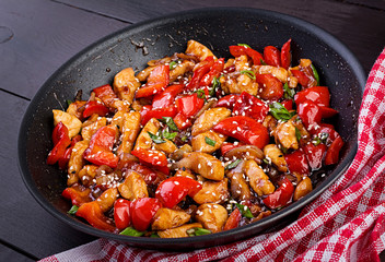 Stir fry chicken, sweet peppers and green onion. Asian cuisine