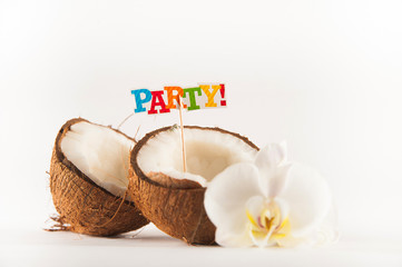 Fototapeta na wymiar Coconut cut in half with white orchid flower isolated on white background. Coconut milk and coconut pulp with the inscription Party close up and copy space.