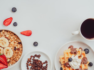 Breakfast berries and oatmeal frame with copy space. Waffle with fruits, chocolate and whipped cream. Flat lay
