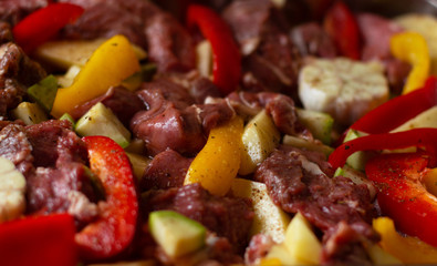 Raw beef meat with raw vegetables: zucchini, garlic, red and yellow pepper with natural spices and herb. Cook delicious dinner.  Healthy diet. Very tasty homely meal