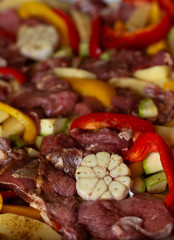 Raw beef meat with raw vegetables: zucchini, garlic, red and yellow pepper with natural spices and herb. Cook delicious dinner.  Healthy diet. Very tasty homely meal