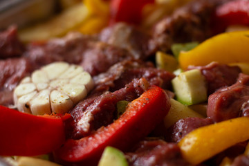 Raw beef meat with raw vegetables: zucchini, garlic, red and yellow pepper with natural spices and herb. Cook delicious dinner.  Healthy diet. Very tasty homely meal