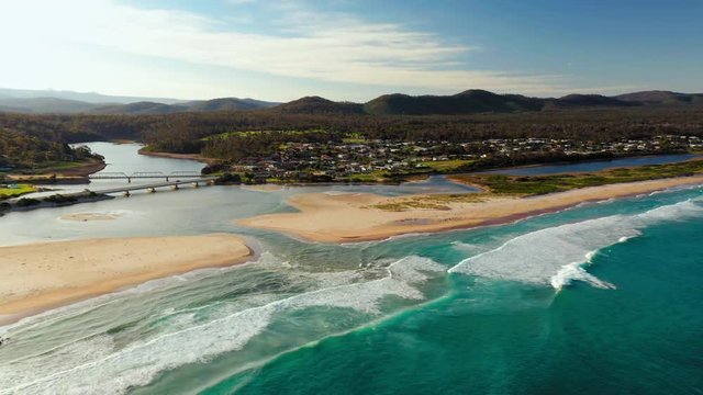 Areal drone shot of the river estuary bridges banks along ocean shore at Scamander Tasmania